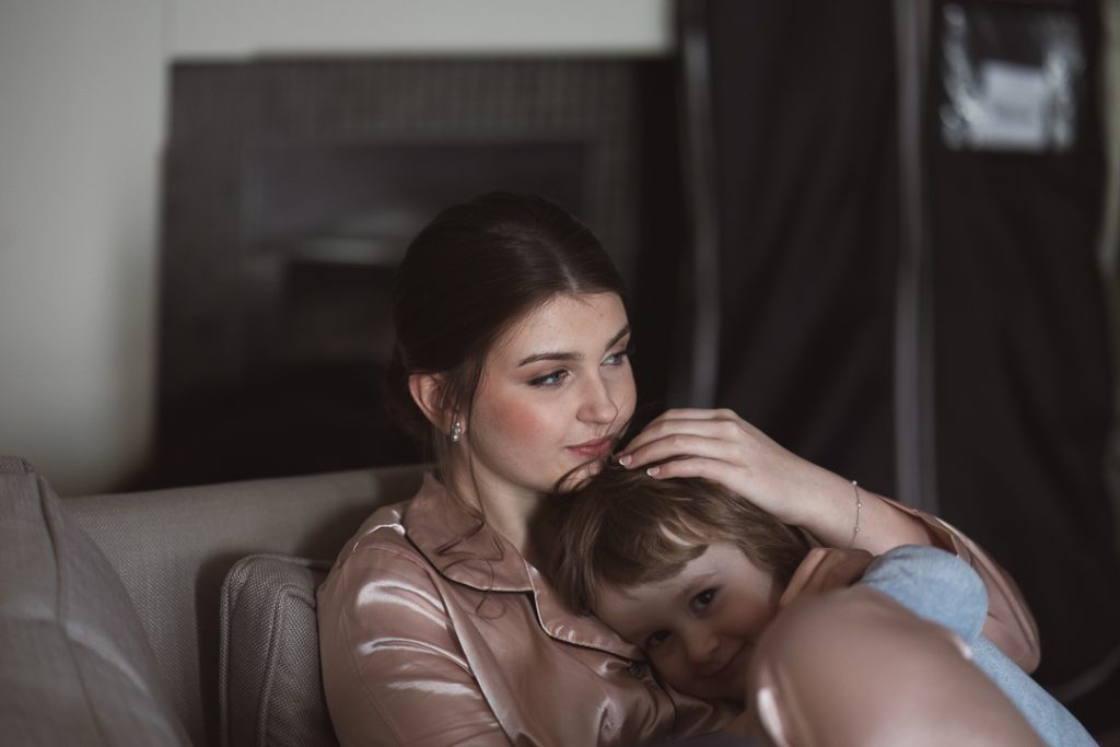 Bride hugging her son — heartfelt moment captured by a documentary wedding photographer